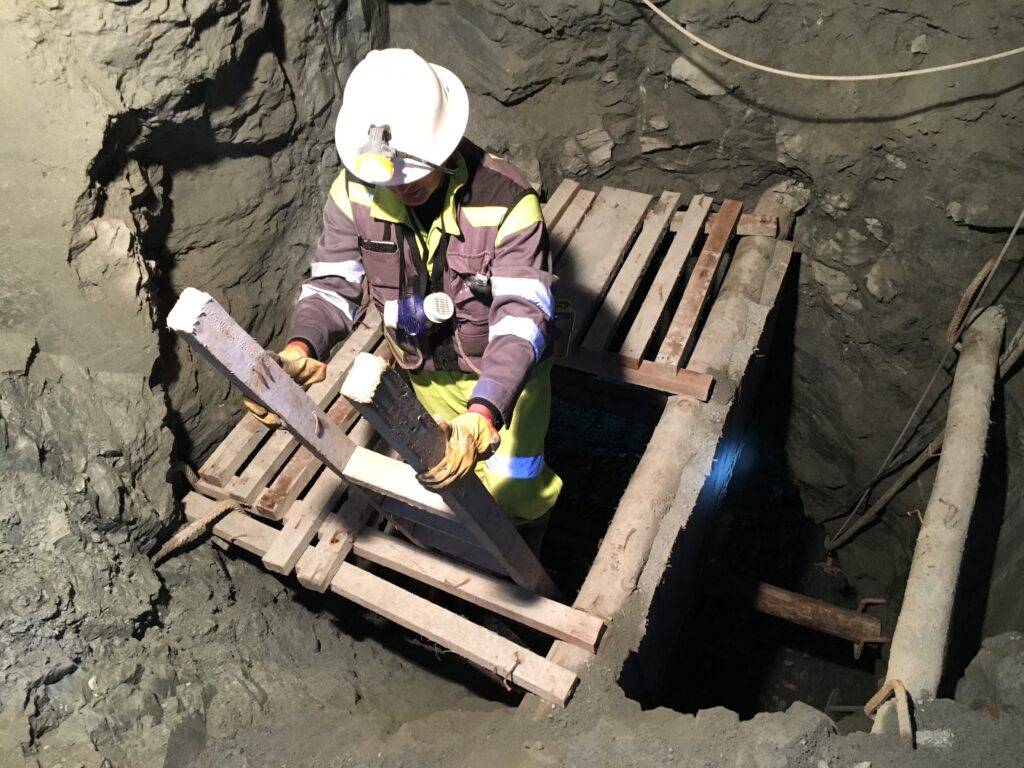 Underground miner going down a mine